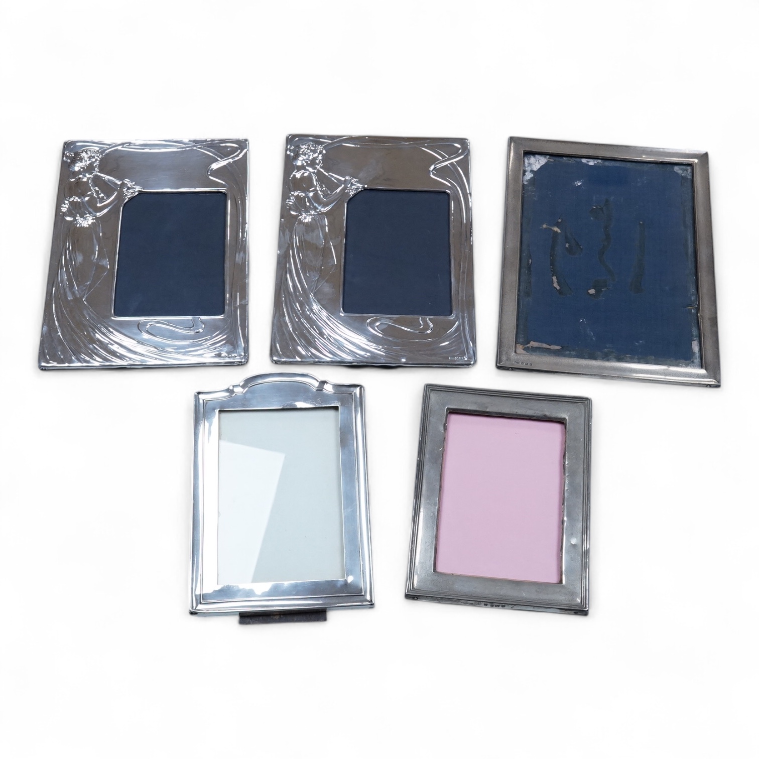 Three assorted George V silver mounted photograph frames, largest 23.9cm by 18.2cm, together with a pair of modern Art Nouveau style silver mounted photograph frames, PP & A, London, 1981.
